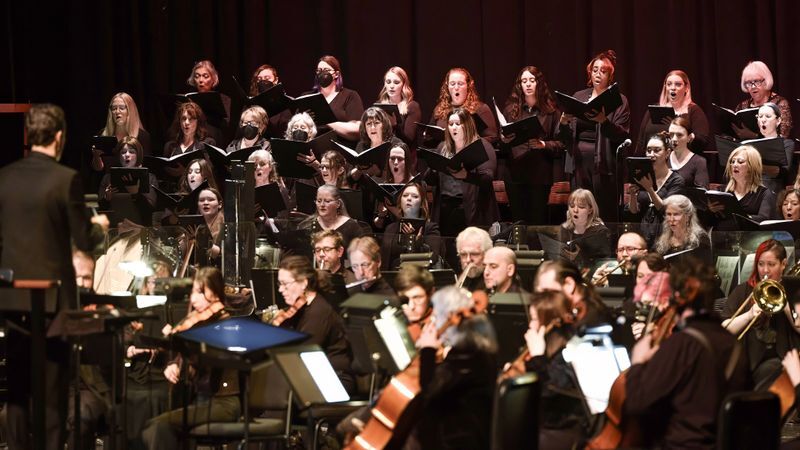 Chorus women singing with symphony